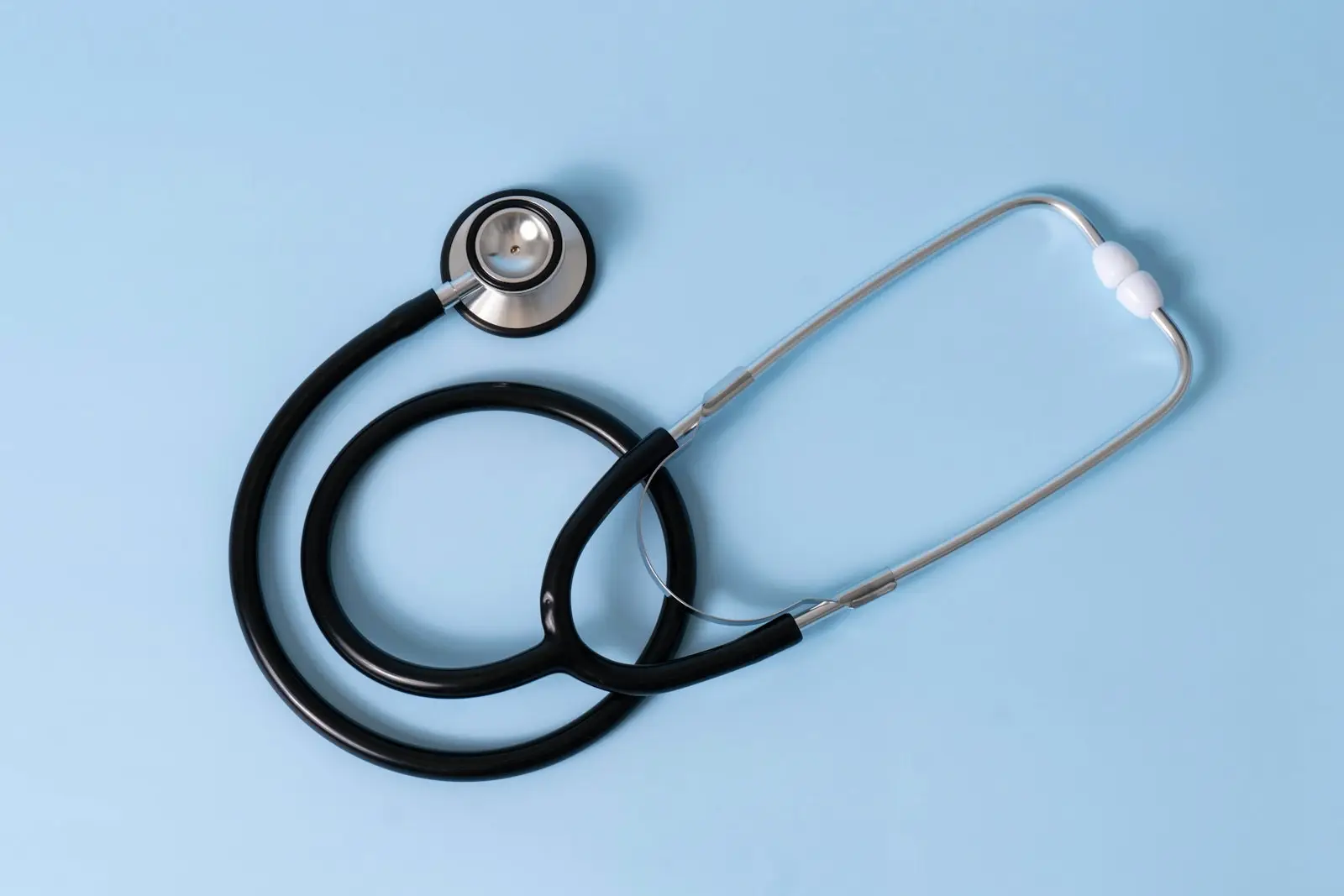A stethoscope on a pale blue background