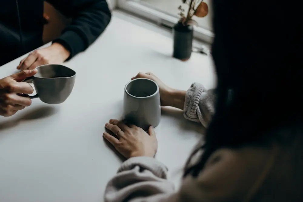 Two people in conversation at a table
